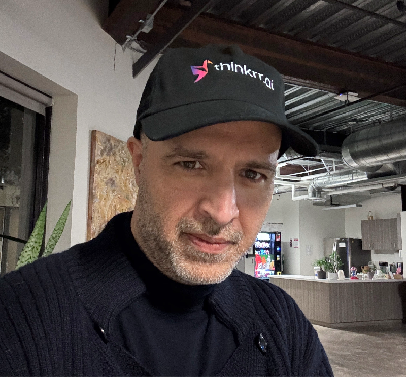 Mohan Gulati wearing a Thinkrr cap at the office